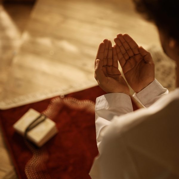 Close up of Middle Eastern man praying at home. Close up of Muslim believer reciting dua during prayer at home.